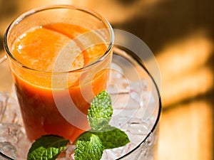 Mix fruite juice in glass with ice put on wood table