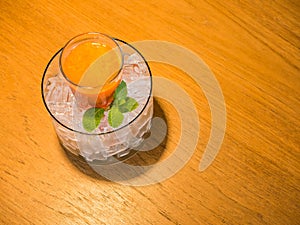 Mix fruite juice in glass with ice put on wood table