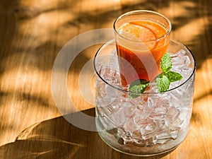 Mix fruite juice in glass with ice put on wood table