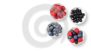 Mix of fruits on white bowls on white background with copy space. Concept of juicy, fresh, organic and healthy. Top view of