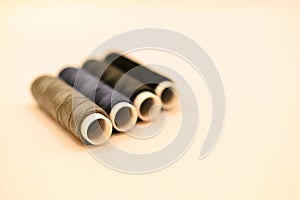 mix of grey, blue and black colored threads on white background