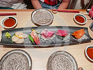 Mix of Japanese food sushi and rolls on restaurant table in restaurant in Central, Hong Kong