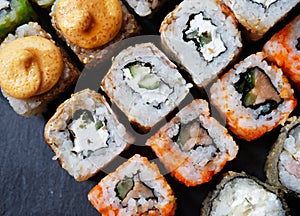 Mix of Japanese rolls in on a black background