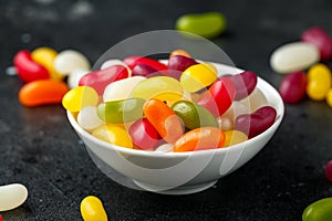 A mix of jelly beans candy in white bowl. sweet food