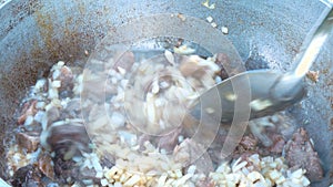 Mix meat and onions for Pilaf