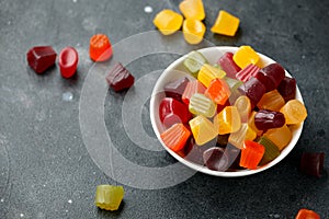 A mix of Midget Gems candy in white bowl. sweet food