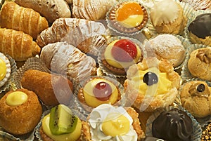 mix of mini pastries, including cannoli, cream and fruit, chocolate etc