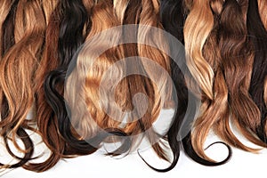 Mix of natural extensions hair: blond, red, brown. Strands of ha