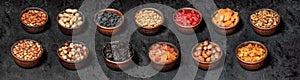 Mix of nuts and dried fruits on dark background