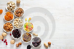 Mix of nuts and dried fruits in small bowls. Healthy and tasty snack