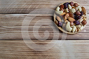 Mix of nuts and dried fruits at weathered wooden background