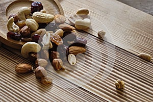 Mix of nuts and dried fruits at weathered wooden background