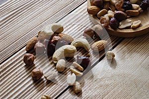 Mix of nuts and dried fruits at weathered wooden background