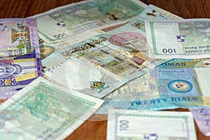 A mix of Omani Riyal Currency Bills spread out on the table