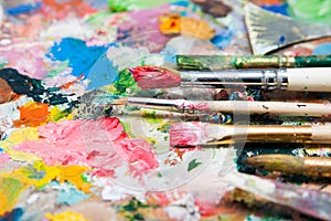 Mix of paints and paintbrushes close up