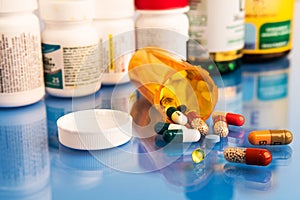 Mix of pills capsules supplements and Pharmacogenomics on blue medical table photo