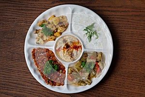 Mix plate arabic food with vegetarian spread starters on wooden background