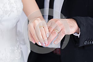Mix race wedding concept, Happy couple spent time together choosing wedding dress and tuxedo in fitting room, beautiful Asian woma