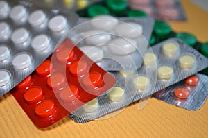 Mix of round and oval medical tablets in pack, tablets packed in blisters. Healthcare and medical concept, closeup