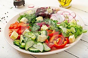 Mix salad from fresh vegetables and greens herbs.