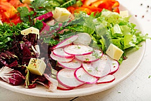 Mix salad from fresh vegetables and greens herbs.