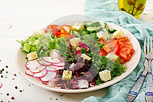 Mix salad from fresh vegetables and greens herbs.