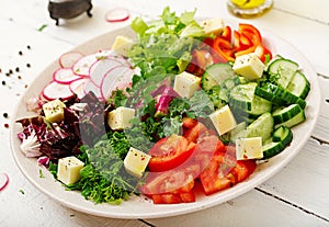 Mix salad from fresh vegetables and greens herbs.