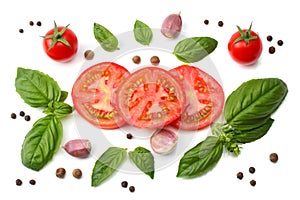 mix of slice of tomato, basil leaf, garlic and spices isolated on white background. top view