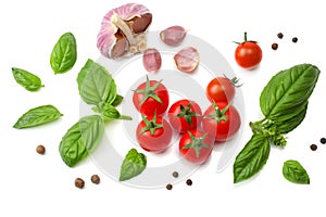 mix of slice of tomato, basil leaf, garlic and spices isolated on white background. top view