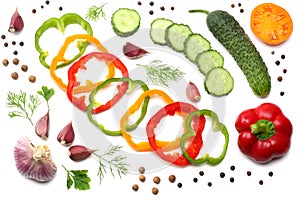 mix of sliced cucumber, garlic, sweet bell pepper and parsley isolated on white background. top view