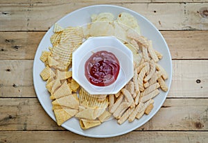 Mix snacks in dish with ketchup