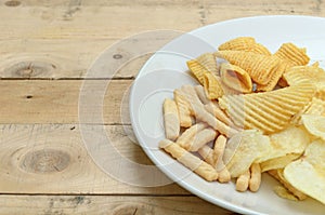 Mix snacks in dish on wood background