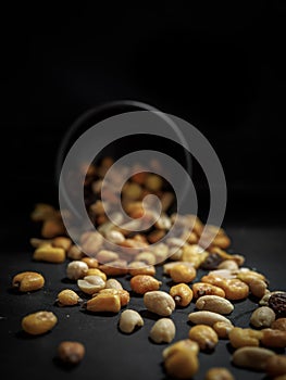 Mix of tasty nuts on dark table