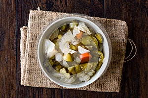 Mix of Turkish Pickles with Hot Green Pepper, Cabbage, Sauerkraut, Carrot and Cucumber in Bowl.