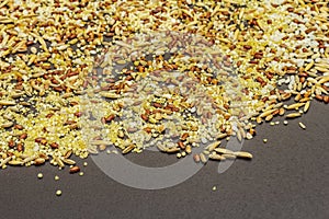 Mix of variety of cereals scattered on black stone background