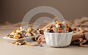 The mix of various nuts and raisins on a beige background