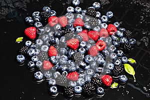 Mix of wild forest berry fruits. Blueberry, raspberry, blackberry. Healthy fresh berries background. Berries as background. Summer