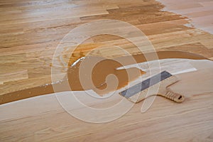 Mix of wood dust, wood varnish, spatula on the floor