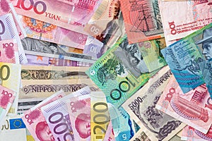 Mix of world currencies on wooden background