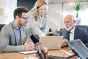 Mixed age group of business professionals having meeting in an office