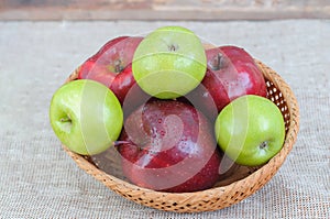 Mixed apples in basket on the table