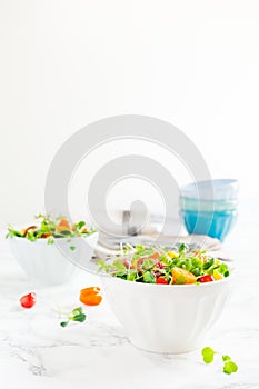 Mixed baby greens and cherry tomatoes salad in bowl. Superfood s