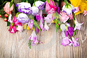 Mixed beautiful flowers on wooden background