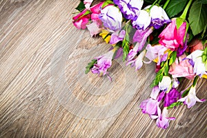 Mixed beautiful flowers on wooden background