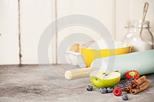 Mixed berries, baking ingredients and utensils