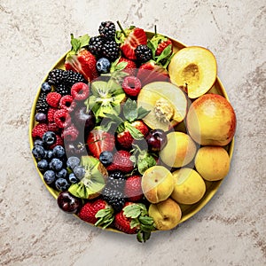 Mixed berries flat lay with peaches and kiwis food photography