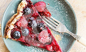 Mixed berries pie on blue ceramic plate