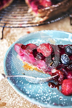 Mixed berries pie on blue ceramic plate