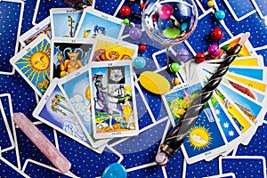 Mixed blue tarot cards with a magic ball and wand.