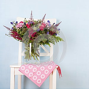 Mixed bouquet flowers on chair